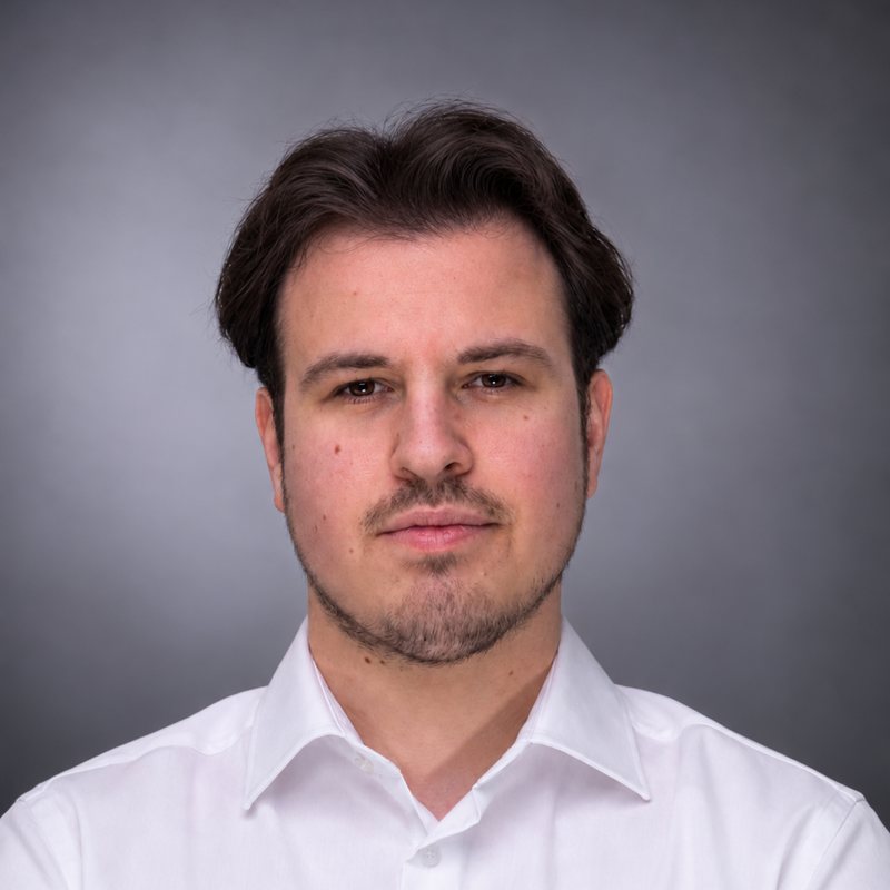 Philipp Staufenberger, technical co-founder of Trusters, in a white shirt against a grey backdrop