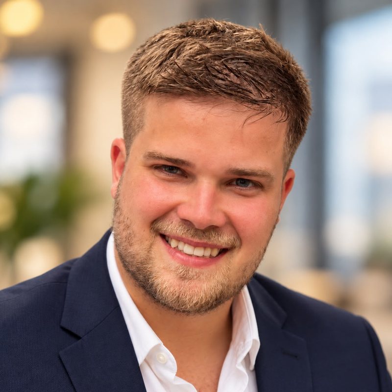Robin Roßnagel, technical co-founder of Trusters, in a navy jacket and open white shirt